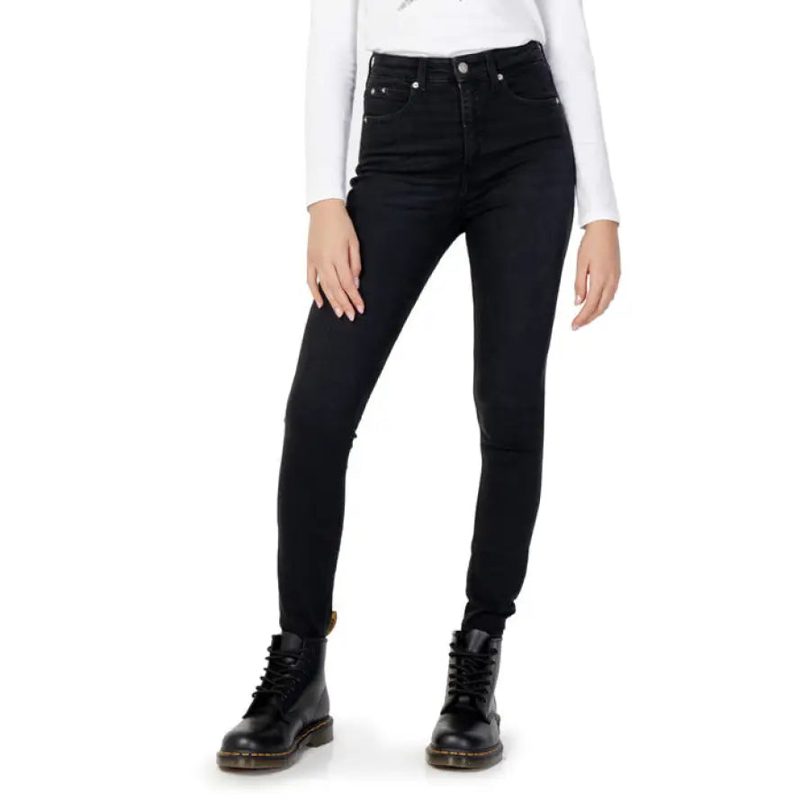 Woman in Calvin Klein white shirt and black jeans