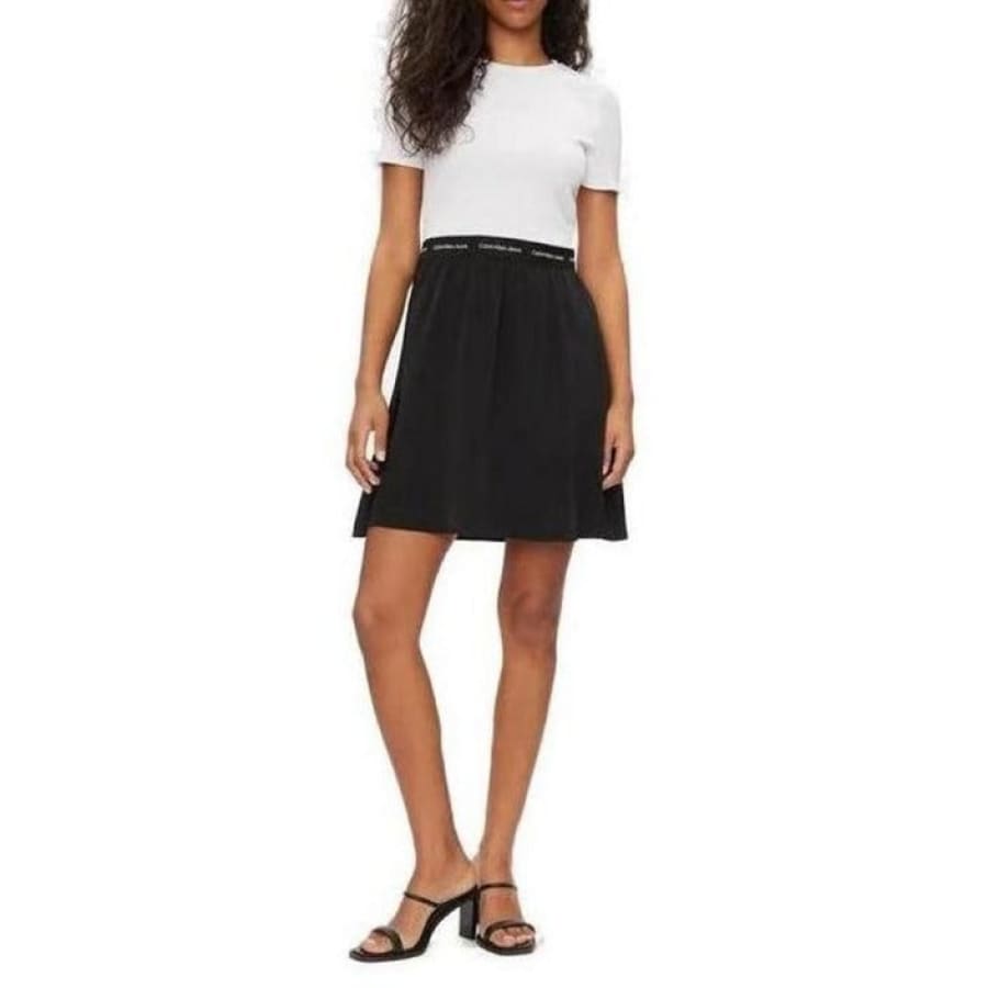 Woman wearing Calvin Klein Jeans dress, white shirt and black skirt combo