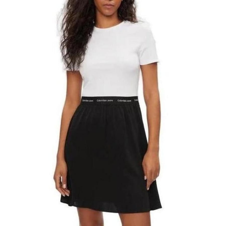 Woman wearing Calvin Klein Jeans dress in white shirt and black skirt