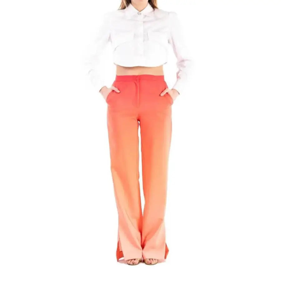 
                      
                        Woman in Silence urban style clothing, white shirt and orange trousers, city fashion
                      
                    