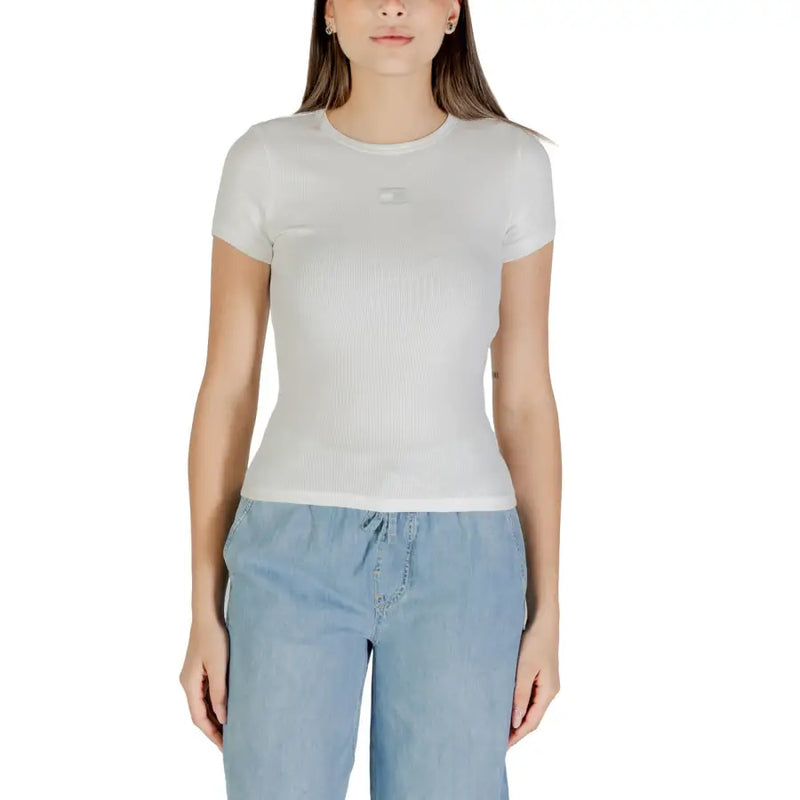Woman wearing white short-sleeve T-shirt and light blue drawstring pants for Tommy Hilfiger collection