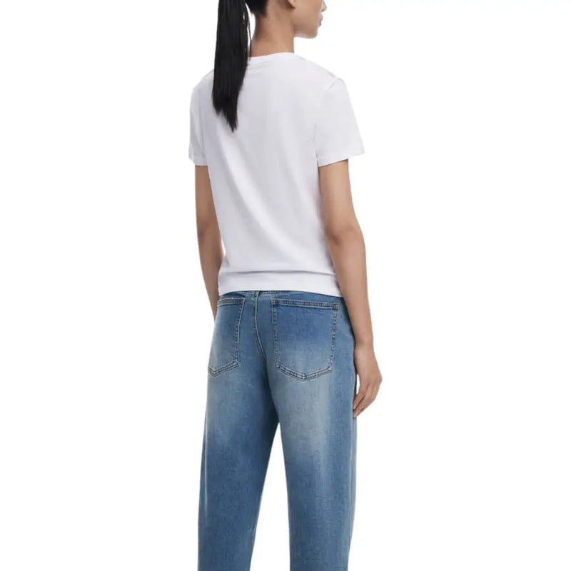 Woman wearing Desigual White Print Round Neck T Shirt with light blue denim jeans