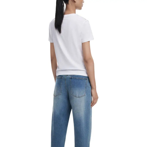 Woman wearing Desigual White Print Round Neck T Shirt with light blue denim jeans