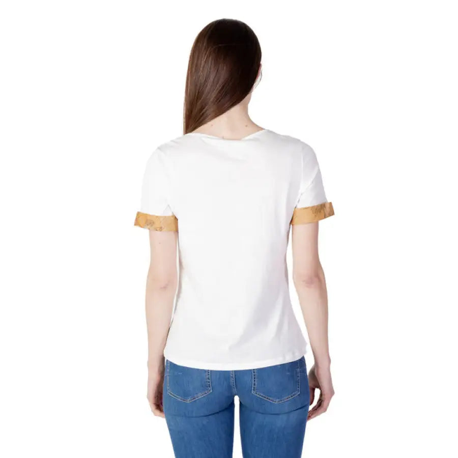 Woman in an Alviero Martini Prima Classe gold trim white T-shirt