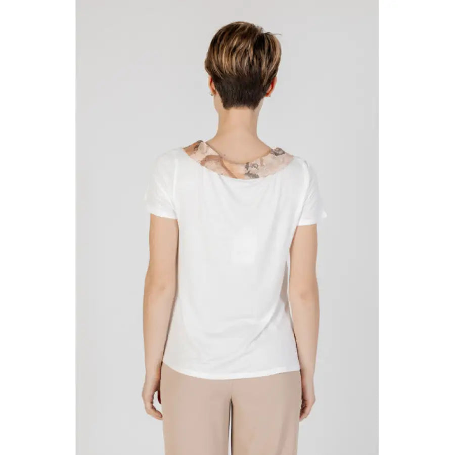 
                      
                        Alviero Martini Prima Classe woman wearing white t-shirt with bow detail on back
                      
                    