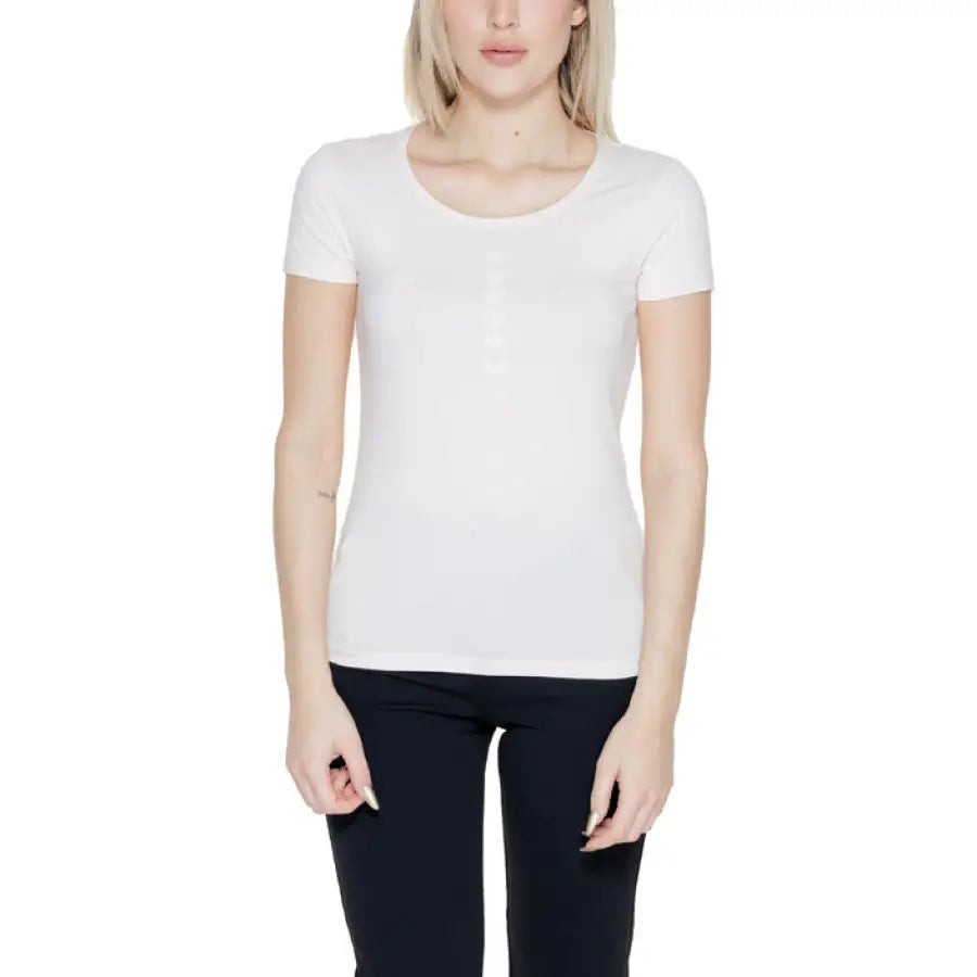 
                      
                        Woman in white EA7 t-shirt showcasing urban city style fashion
                      
                    