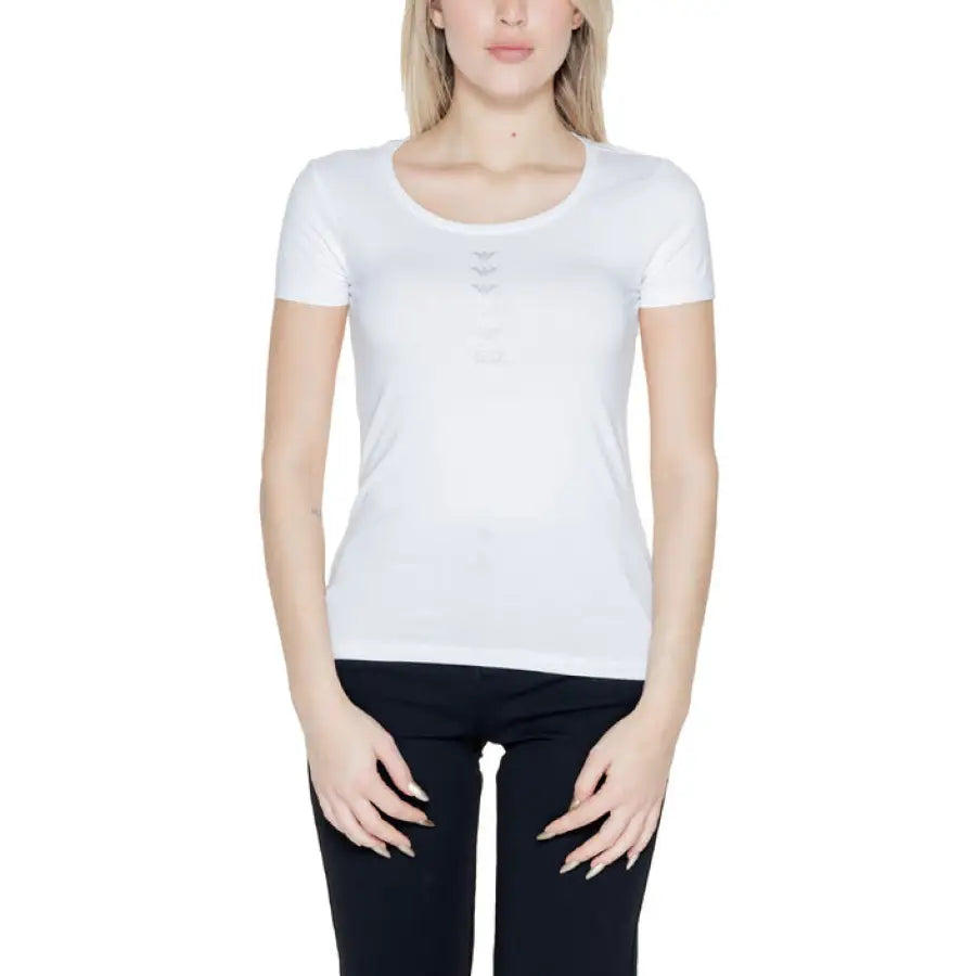 Woman in white EA7 t-shirt showcasing urban city style fashion