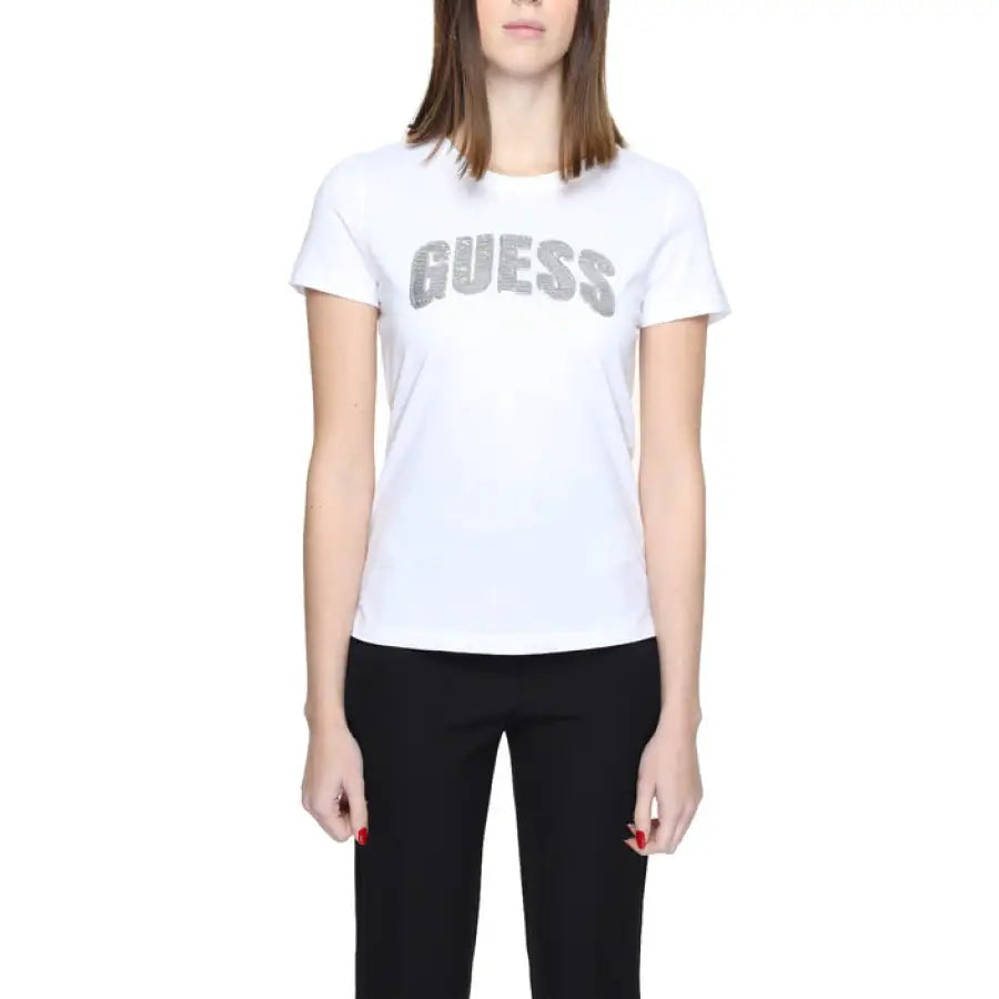 Woman in urban style clothing, white Guess t-shirt with logo, epitomizing urban city fashion