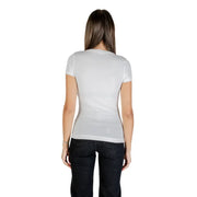Woman wearing Guess White Rhinestone Round Neck Tee and dark jeans, back view