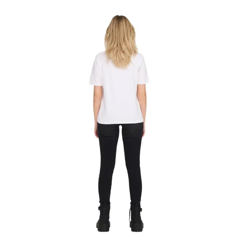 Woman wearing a white T-shirt and ripped black jeans for the Women’s White T-Shirt and Ripped Black Jeans product display