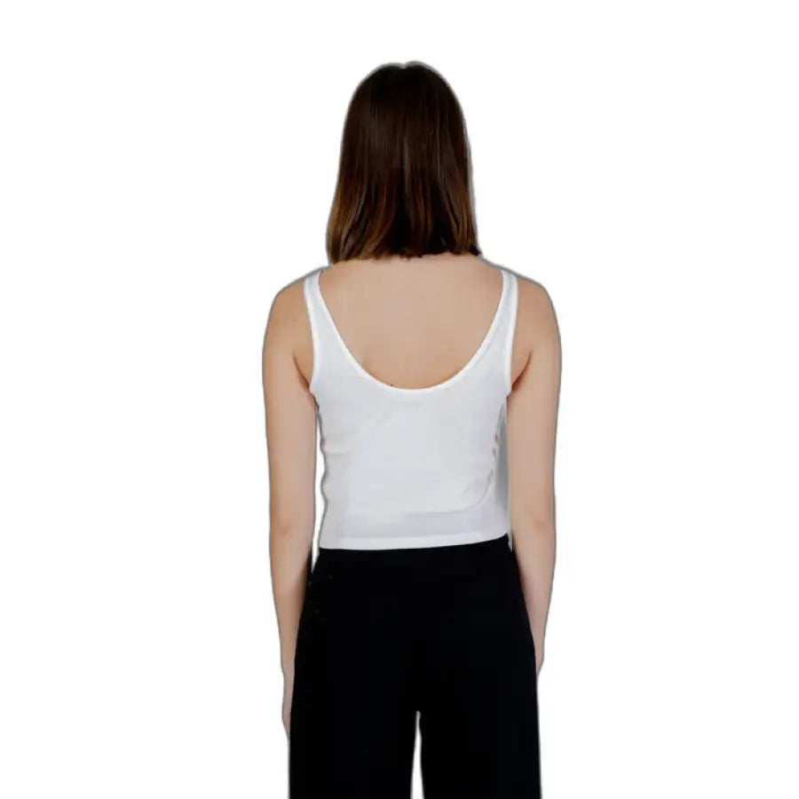 
                      
                        Guess Active Women in white tank top and black pants from Guess Active Guess collection
                      
                    