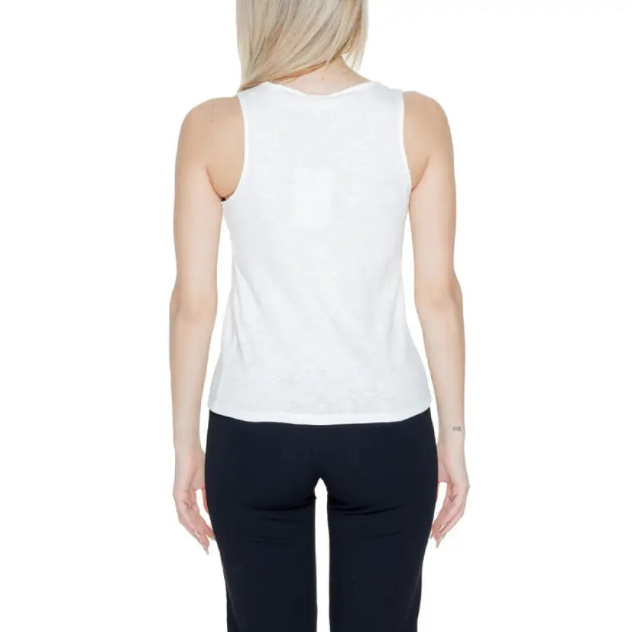 Woman in white tank top embodying urban city style from Jacqueline De Yong collection