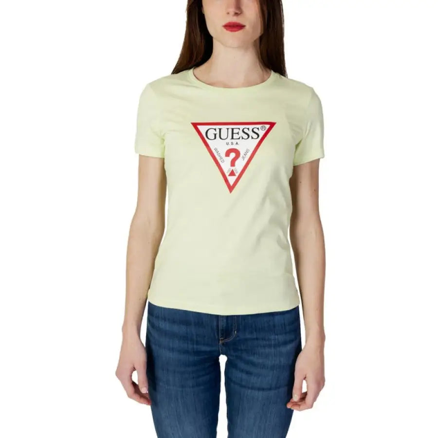 Woman in yellow Guess T-shirt with logo, urban city style fashion
