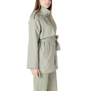 Woman wearing a belted sage green trench coat from the Women’s Belted Sage Green Trench Coat collection