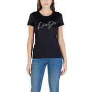 Woman wearing black crew-neck short-sleeve Liu Jo T-shirt with sparkly logo and blue jeans