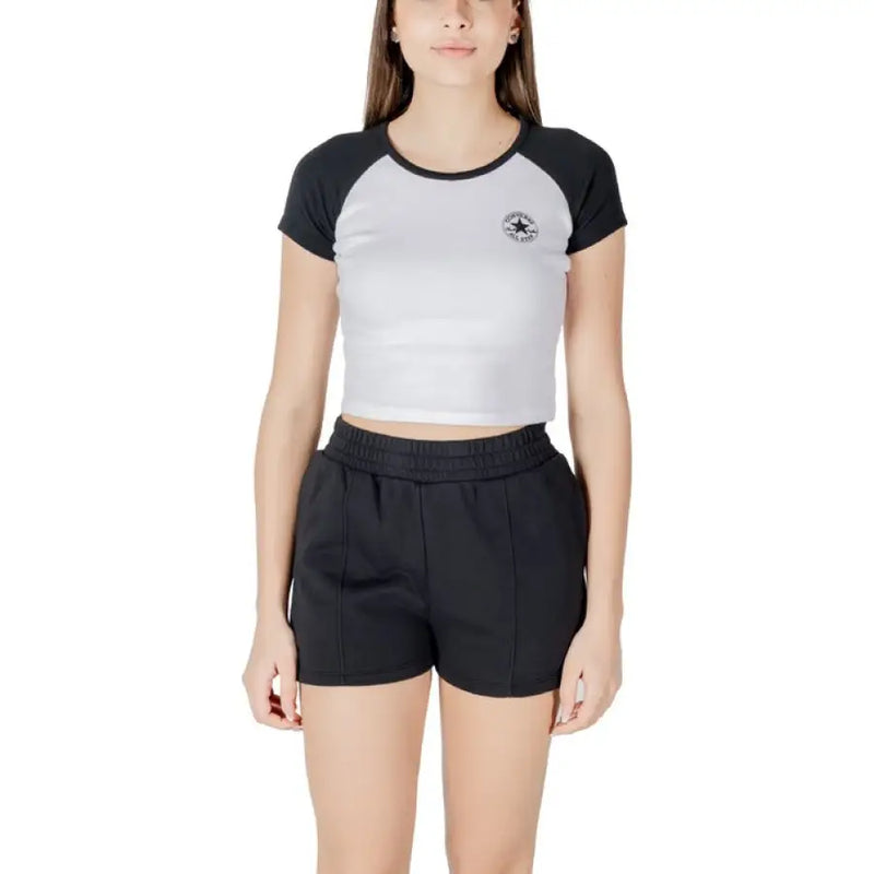Women wearing a black and white crop top with black shorts for a stylish look