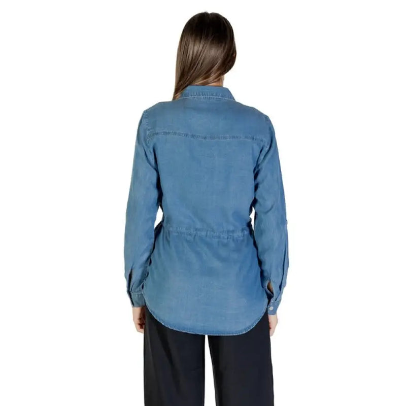 Woman wearing a blue denim drawstring shirt showcasing casual style and comfort