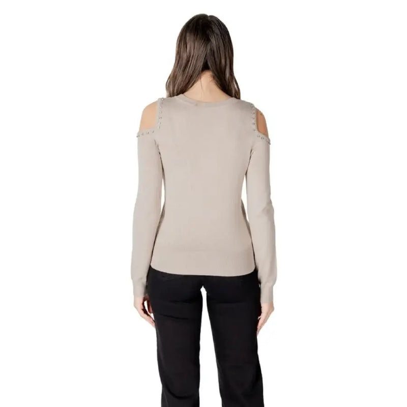 Woman wearing a cold-shoulder long-sleeve sweater from Women Cold Shoulder Sweater Collection