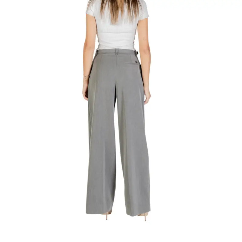 Woman wearing Liu Jo grey high-waisted wide-leg palazzo trousers with side buckle detail