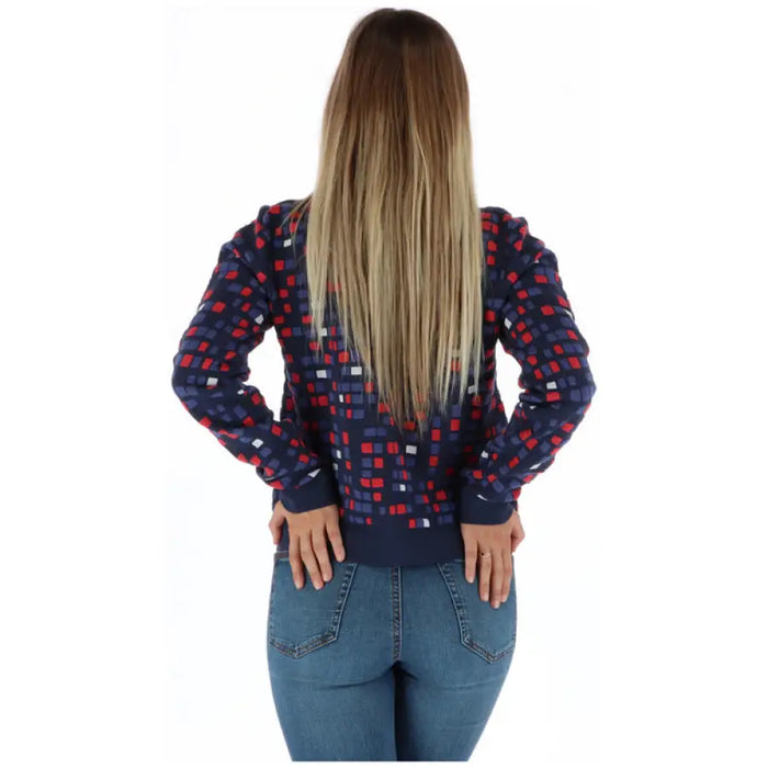 Woman wearing a patterned sweater cardigan and jeans from the Women Patterned Sweater Cardigan and Jeans Collection