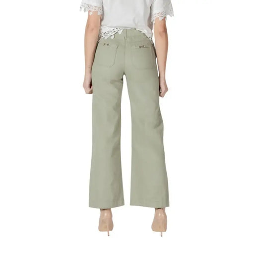 Woman wearing sage green wide-leg pants from the Women’s Light Green Wide Leg Pants collection