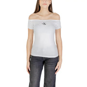 Woman wearing a white off-the-shoulder Calvin Klein Jeans top with a black CK logo