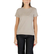 Beige Guess Women Rhinestone Round Neck T-Shirt with subtle chevron design and dark blue jeans