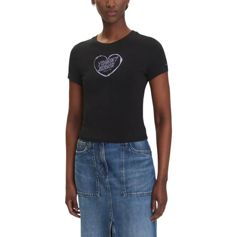Women wearing black organic cotton T-shirt with heart graphic and blue denim midi skirt