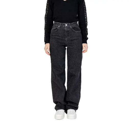 Woman wearing Women’s Black Wide Leg Jeans and black top showcasing stylish attire