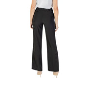 Women’s black wide-leg trousers with a white top and nude heels from Rinascimento fall winter collection