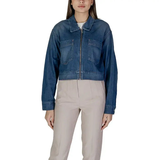Woman wearing a denim zip-up jacket, casual fashion apparel for women
