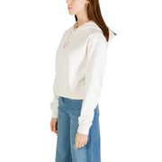 Women’s off-white organic cotton hoodie with long sleeves paired with blue jeans