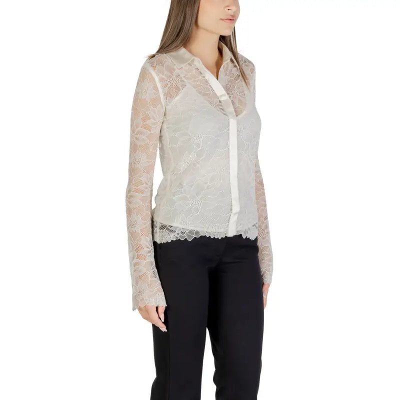 Women’s long-sleeved sheer lace white shirt over camisole with black trousers
