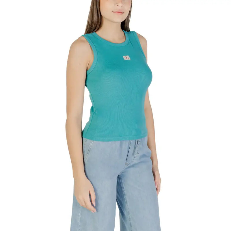 Women wearing teal ribbed tank top with chest patch and light blue wide-leg pants