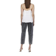 Women’s white polyester tank top with delicate thin spaghetti straps and a relaxed slightly flared silhouette