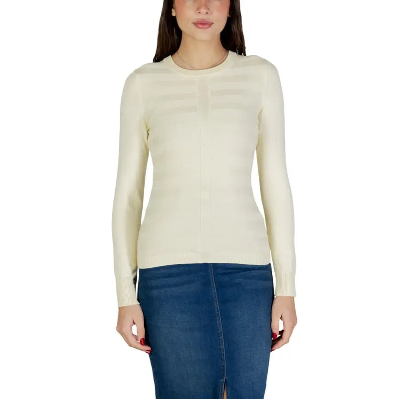 Cream-colored long sleeve viscose knit top with ribbed texture and horizontal panel detailing across the chest