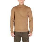Camel-colored turtleneck sweater with ribbed cuffs and hem, likely made of cotton or a similar soft fabric.