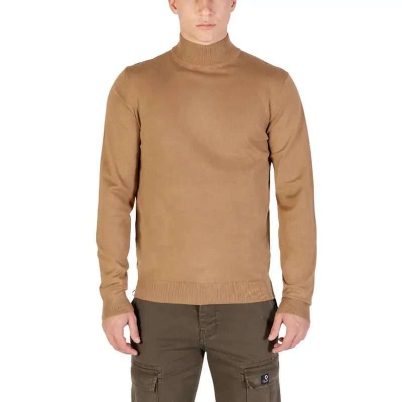 Camel-colored turtleneck sweater with ribbed cuffs and hem, likely made of cotton or a similar soft fabric.