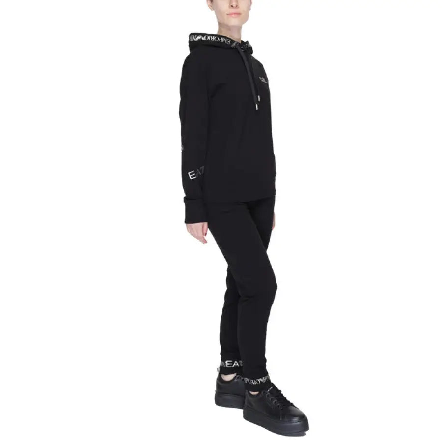 
                      
                        Young boy in urban style clothing with EA7 black hoodie and pants in urban city fashion
                      
                    