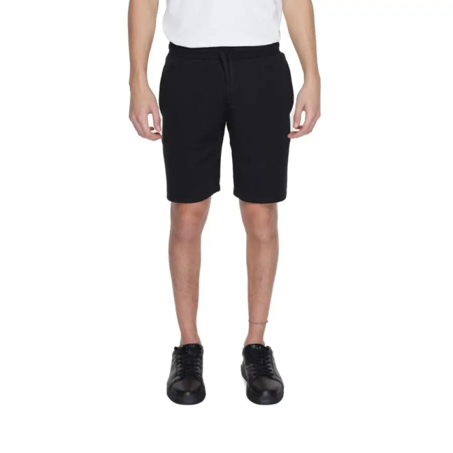 Young boy models Emporio Armani Underwear men’s shorts in black and white