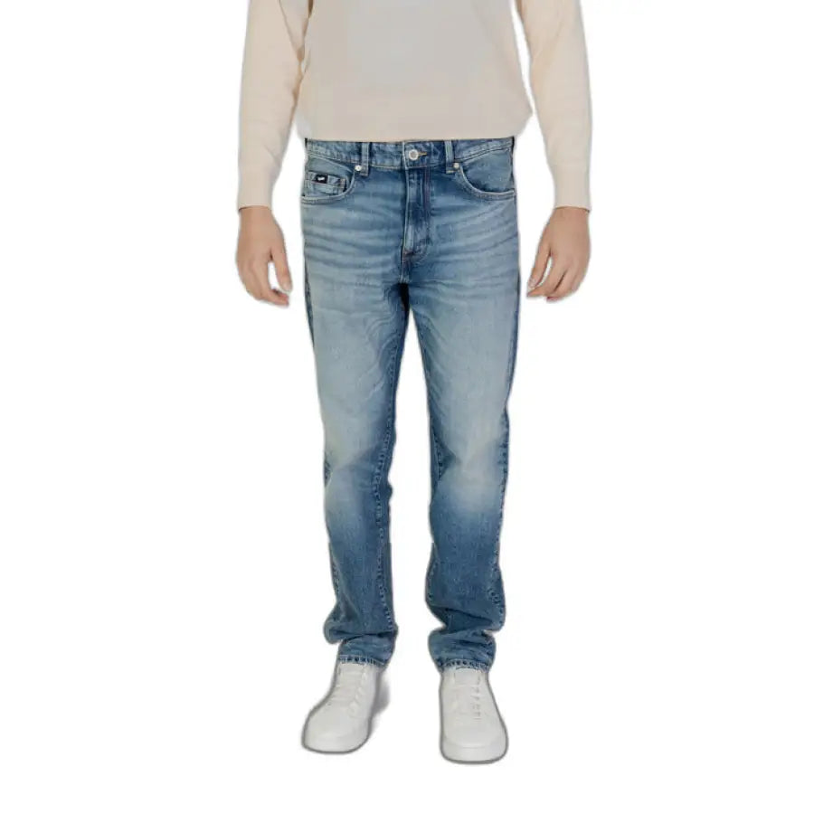 Young boy in white sweater and Gas Men Jeans showcasing urban city style clothing
